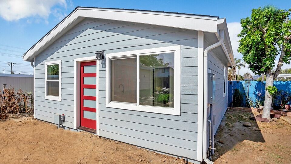 Snap-ADU-San-Diego-Appleton-St-1BR-1BA-482-sqft-Exterior-Shot-Full-View-of-Front-Door-Red-Door-Blue-Home-Dual-Windows - Copy